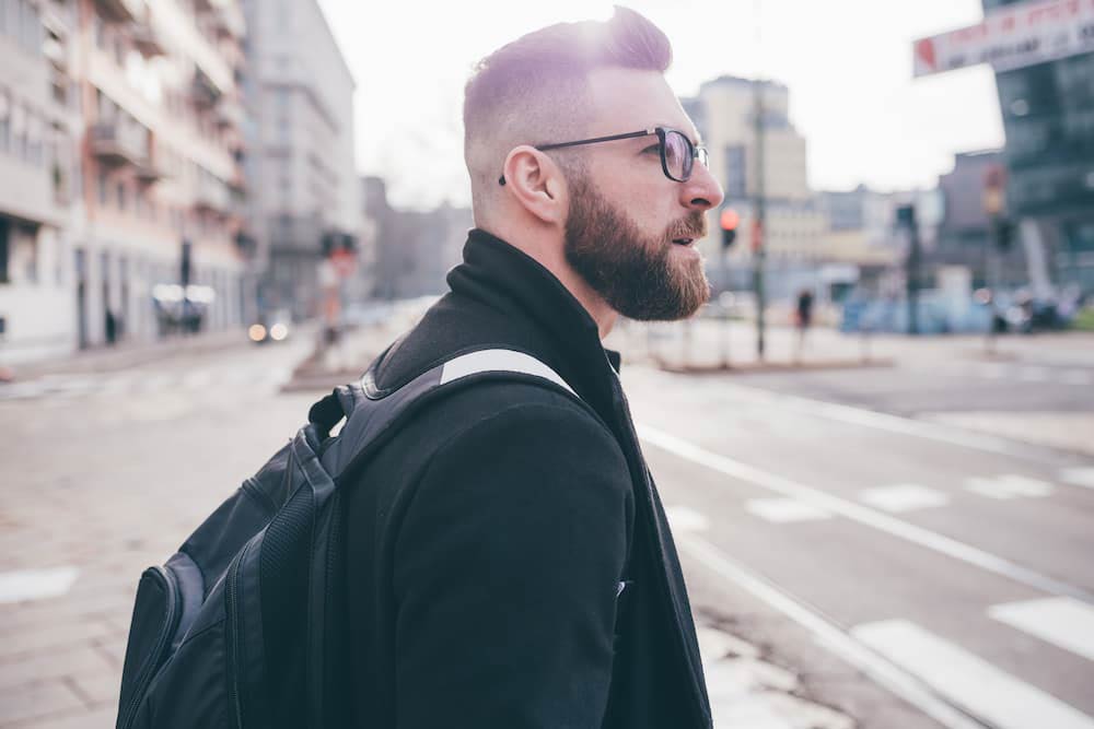 Man With Beard Walking In Urban Street